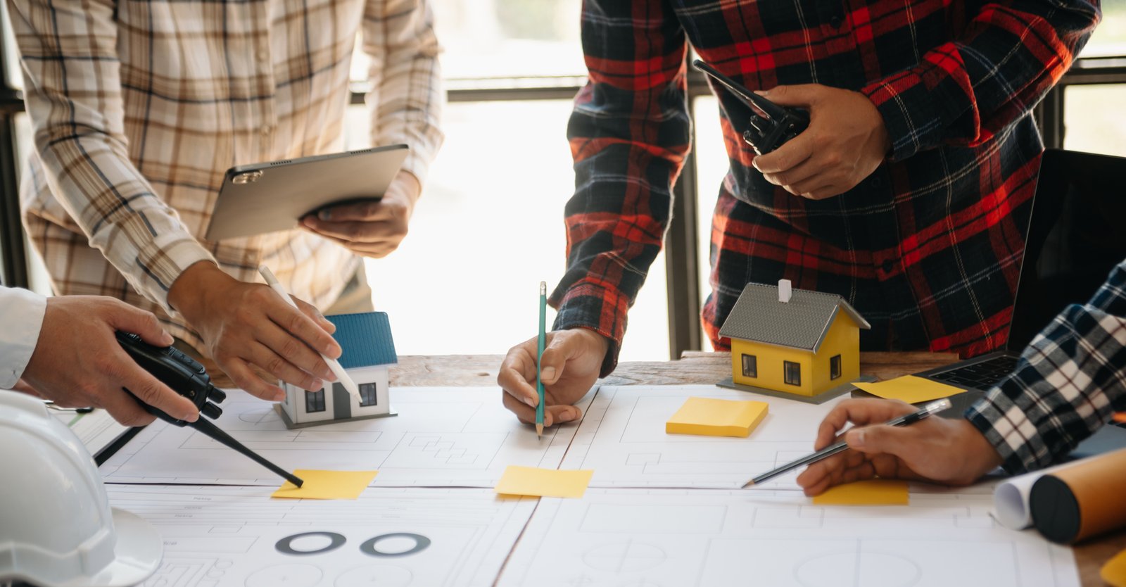Real estate agent writing a business plan at a desk with financial projections