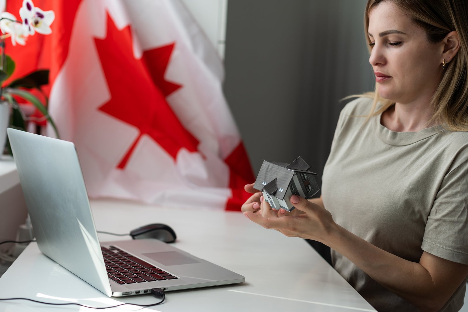 Canadian realtor reviewing an email marketing consent list on a laptop