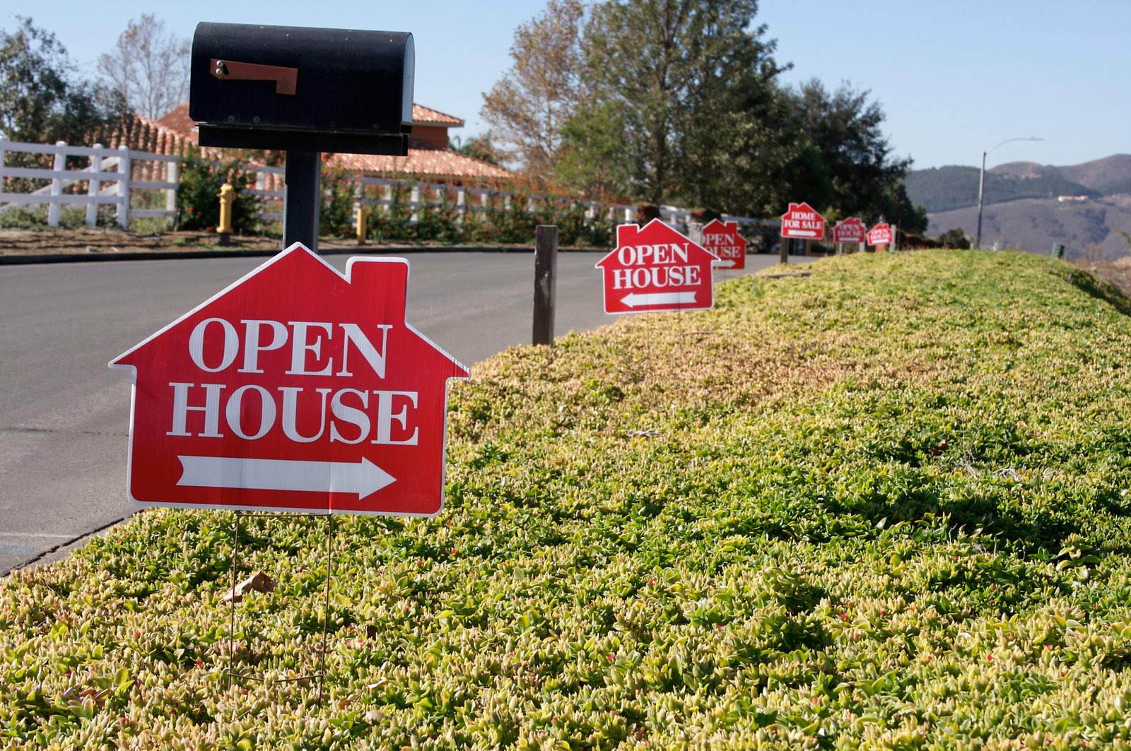 Real estate agent greeting visitors at a Toronto open house with a digital sign-in tablet
