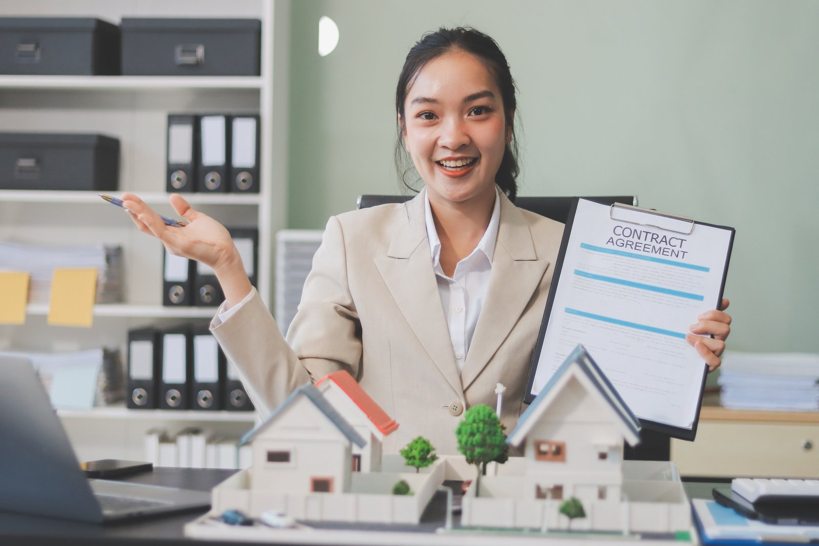 Realtor typing ChatGPT prompts on a laptop