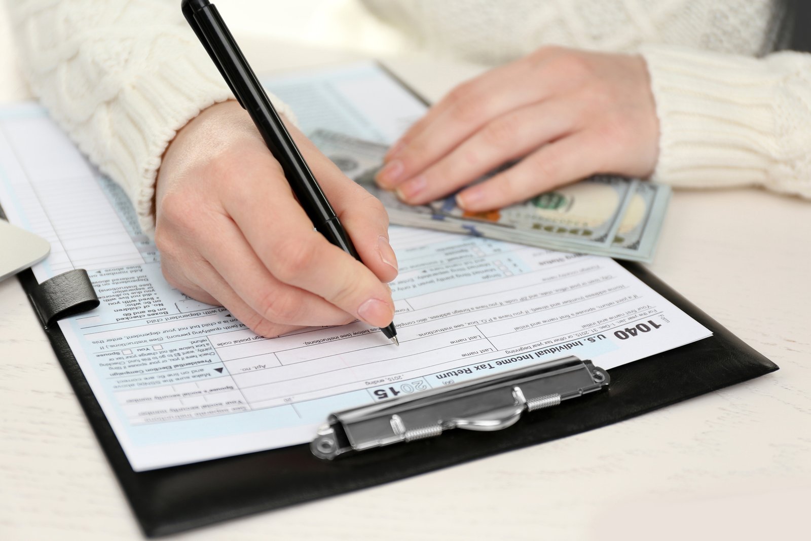 Real estate agent reviewing business expense receipts and tax deduction documentation
